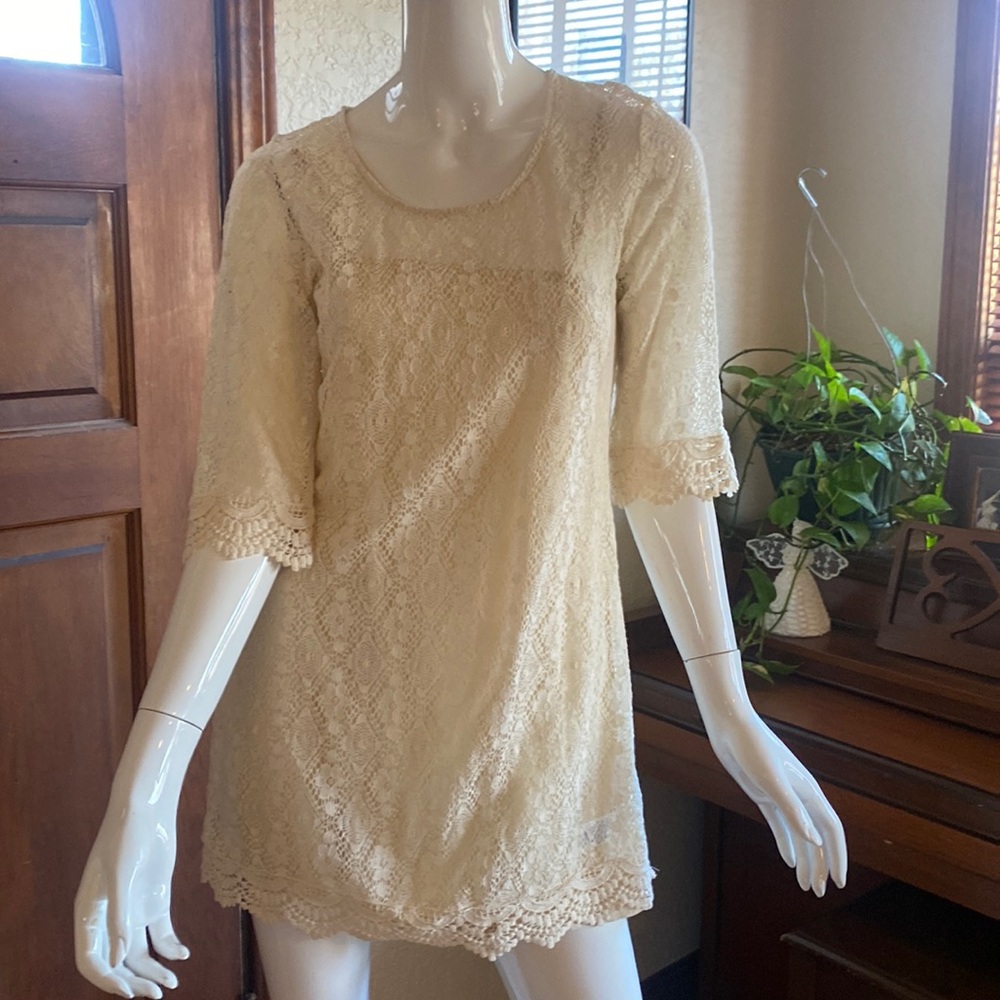 Cream A-line crocheted shift mini dress.